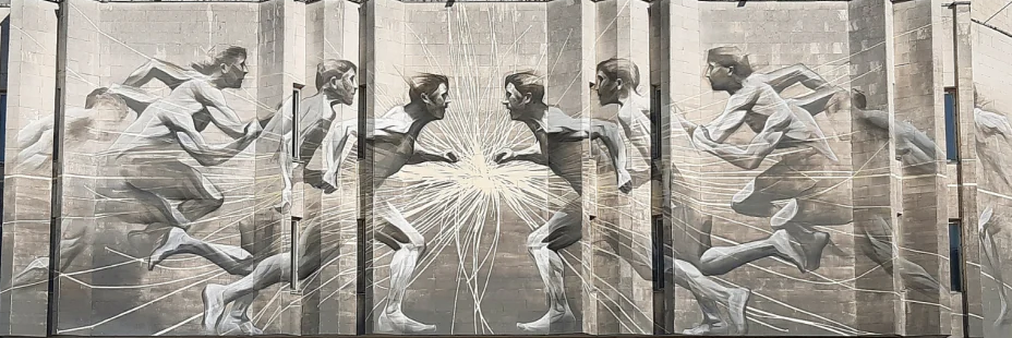 Mural detail on a Kyiv Polytechnic Institute building: figures reaching towards a radiant central form.